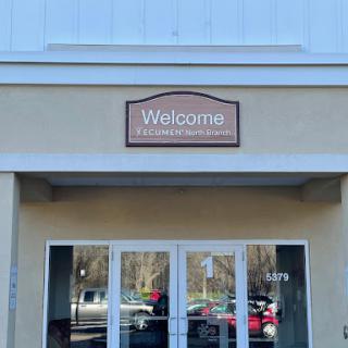 Entrance of a building with a welcoming sign.