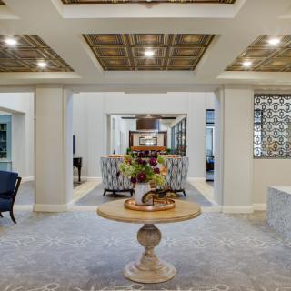 A luxurious entryway featuring elegant furniture and intricate ceiling designs.