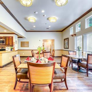 A well-lit dining room with elegant furniture and decor.