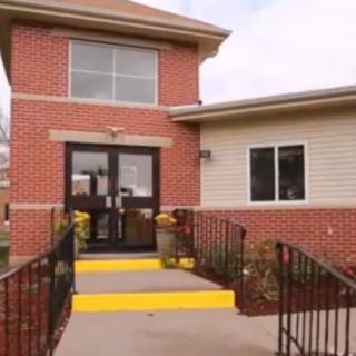 A brick building with an accessible entrance ramp.