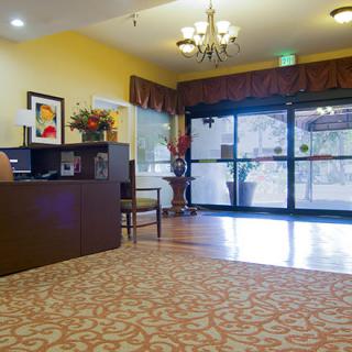 A spacious lobby area with a reception desk and decorative lighting.