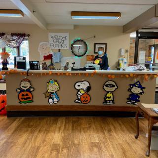 A reception desk adorned with Halloween-themed cartoon character decorations.