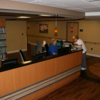 A reception area with people working at a desk.