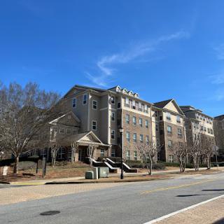 A modern residential building under a clear blue sky.