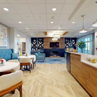 A modern lobby with comfortable seating, stylish decor, and a cozy fireplace.