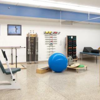 A physical therapy room equipped with exercise tools and rehabilitation equipment.