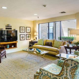 A cozy living room with stylish furniture and large windows.