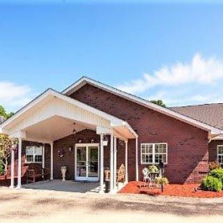 A single-story brick residential building with a covered entrance.