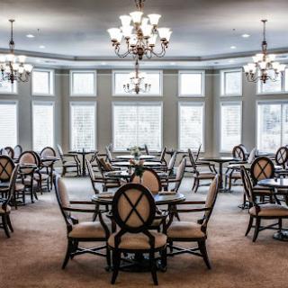 An elegant dining area featuring stylish furniture and ample natural light.