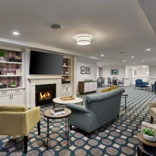 A modern living room with comfortable seating, a fireplace, and a television.
