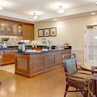 A cozy kitchen and dining area with wooden cabinets and comfortable seating.