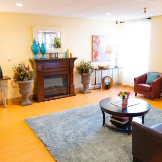 A cozy living room featuring a fireplace, comfortable seating, and stylish decor.
