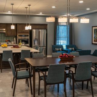 A modern kitchen and dining area with sleek furniture and stylish lighting.