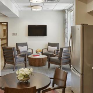 A modern living room with a seating area and television.