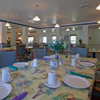 A spacious dining room with tables neatly set for a meal.