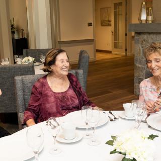 A group of people enjoying a meal together at a restaurant.