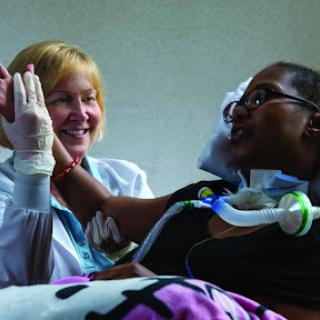 A nurse interacting with a patient, providing care and support in a hospital setting.
