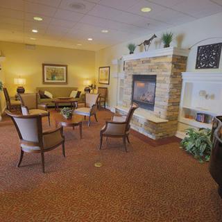 A cozy living room with a fireplace and comfortable seating.