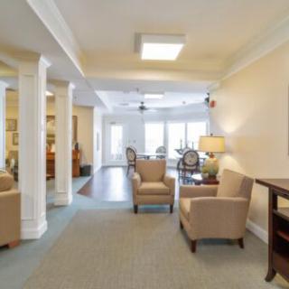 A spacious living room with comfortable seating and warm lighting.
