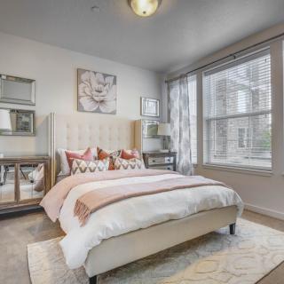 A modern and cozy bedroom with ample natural light and stylish decor.