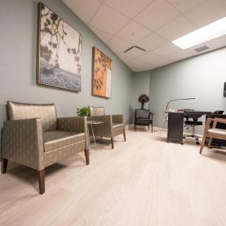 A modern office waiting area with comfortable seating and tasteful decor.