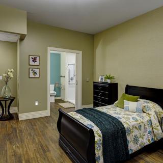 A cozy bedroom with modern decor and a wooden floor.