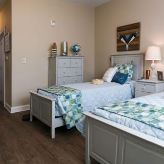 A neatly arranged bedroom with twin beds and stylish decor.