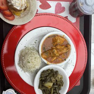 A delicious and hearty meal featuring rice, curry, vegetables, and a side of dessert.