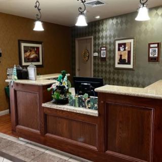 A welcoming reception area with a wooden desk and ambient lighting.