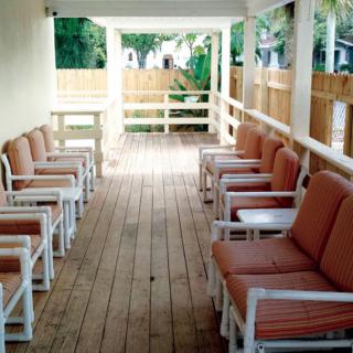 An outdoor patio with seating arrangements on a wooden deck.