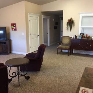A cozy living room with comfortable seating, a television, and decorative elements.