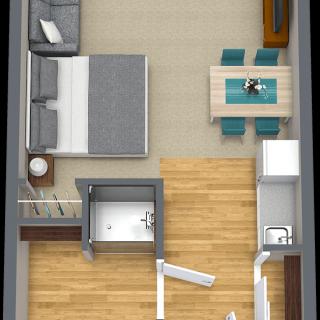 A 3D floor plan of a compact apartment featuring a bedroom, living and dining area, and bathroom.
