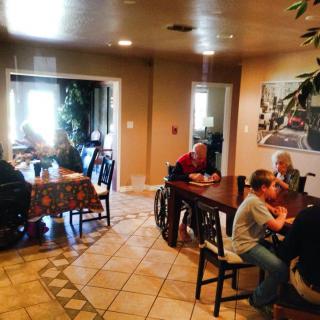 A group of people sitting at tables in a cozy indoor dining area.