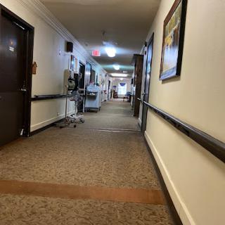 A long, well-lit hallway in a healthcare facility.