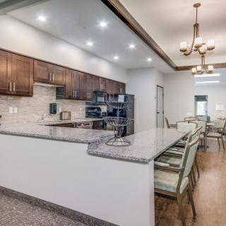 A spacious and modern kitchen with a large countertop and elegant lighting.