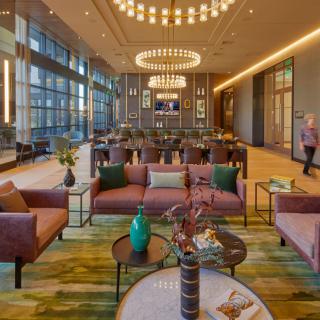 A spacious and modern lobby with stylish furniture and elegant lighting.