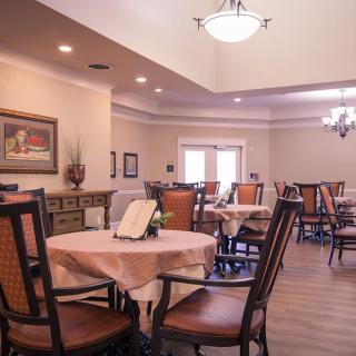 A spacious and elegantly decorated dining room with neatly arranged tables and chairs.