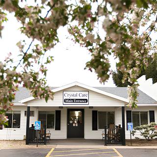A small clinic building surrounded by blossoming trees.