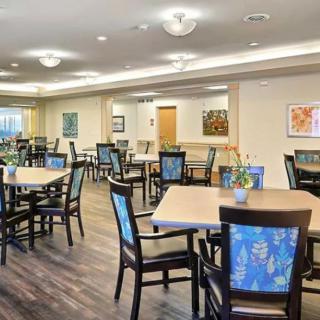 A modern and spacious dining area with neatly arranged tables and chairs.