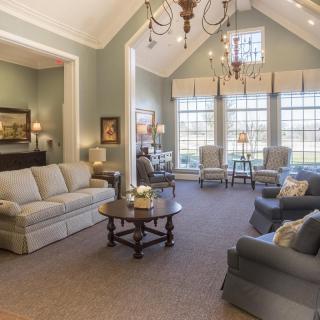 A spacious and elegantly decorated living room with comfortable seating and plenty of natural light.