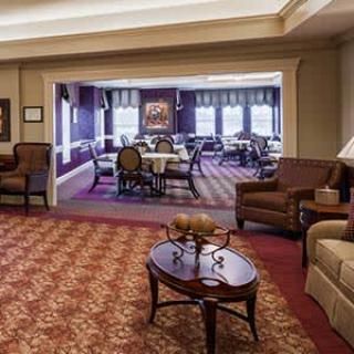 A cozy living room with comfortable seating and a view into a dining area.