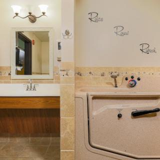 A modern bathroom featuring a stylish vanity with a mirror, decorative tiles, and a bathtub.
