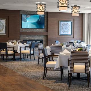 An elegant dining room interior with neatly set tables and stylish decor.