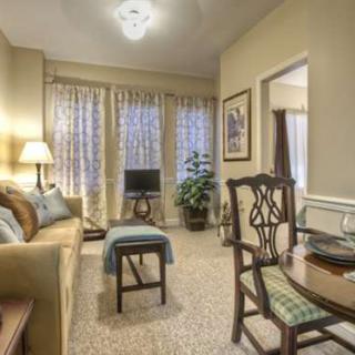 A cozy and elegantly decorated living room with classic furniture.