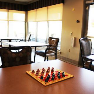 A chess set ready for a game in a bright, inviting community space.
