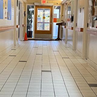 A clean and well-lit hallway leading to an exit.
