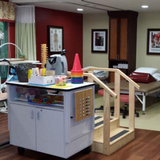 A therapy room equipped with physical rehabilitation tools and exercise equipment.