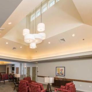 A well-lit lounge area with comfortable seating and stylish pendant lights.