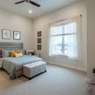 A cozy and minimalistic bedroom with a large window and stylish decor.