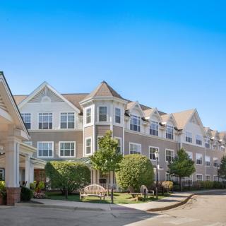 A large residential building with a clear blue sky in the background.